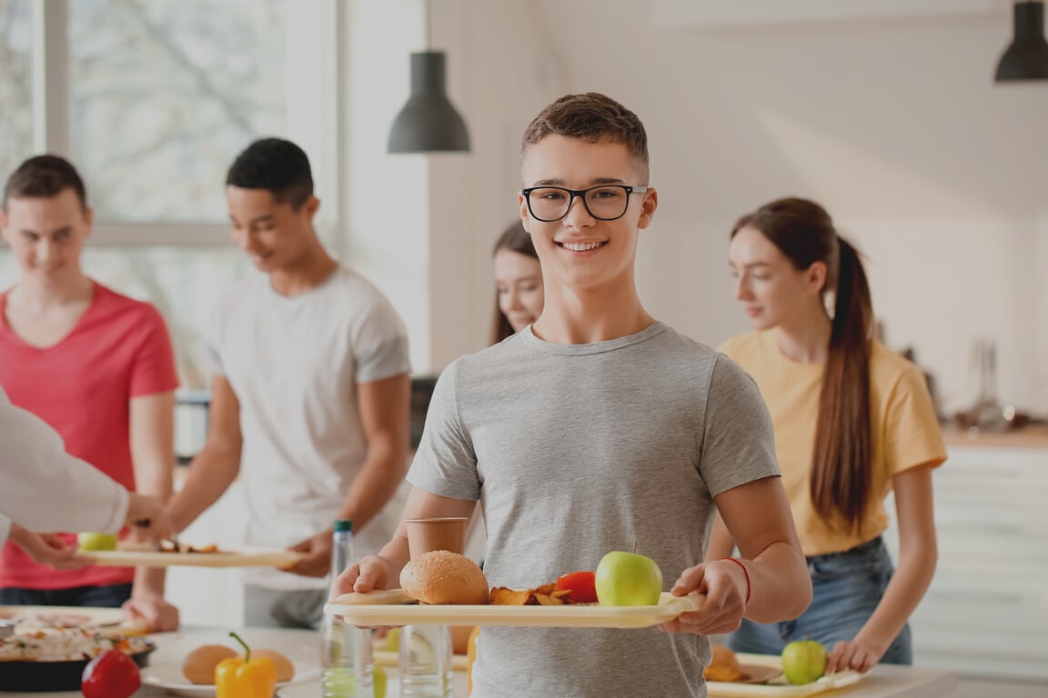 Male Student with Tray of Food in School Canteen